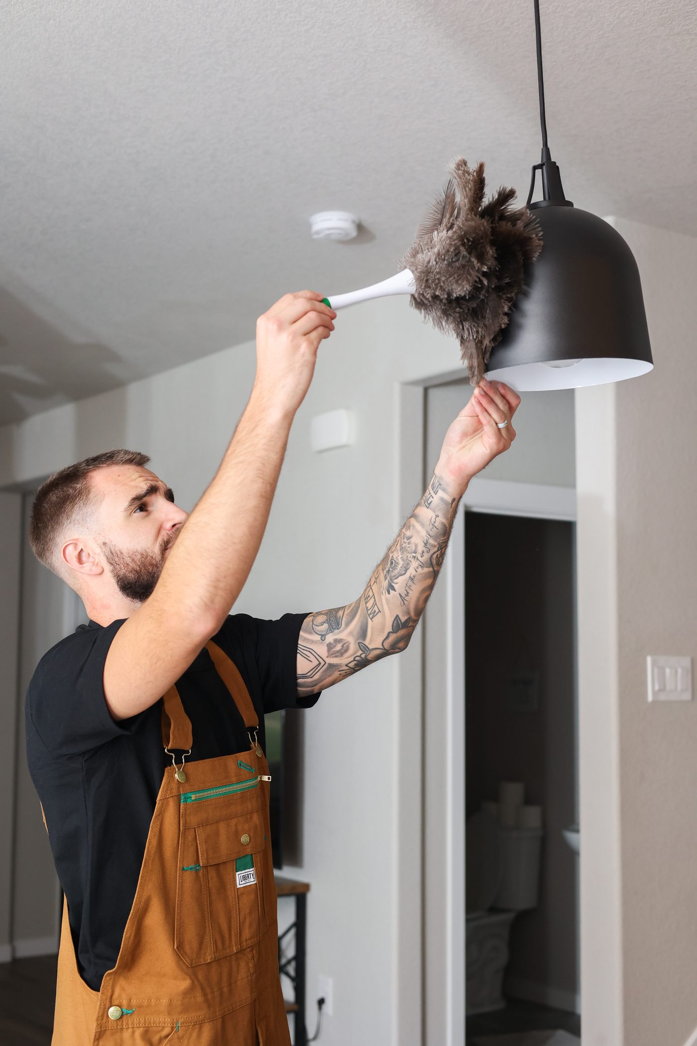 Dusting a pendant light fixture